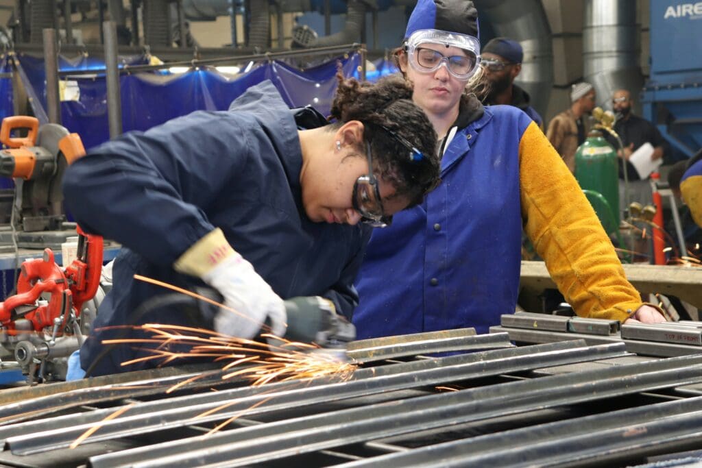 Experienced millwright using precision tools to align factory machinery.