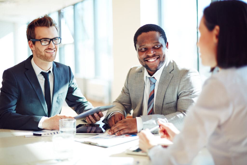 Recruitment agency team collaborating in a modern office meeting to discuss hiring strategies